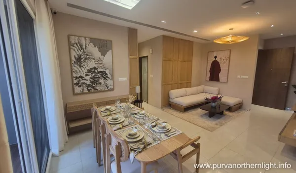 Japanese-inspired dining area and lounge at Purva Northern Lights featuring Zen-style wall art and minimalist wooden furniture.