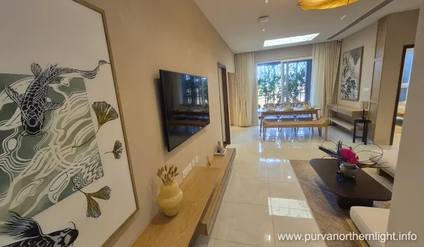 Spacious open-plan living and dining area in a Purva Northern Lights 2 BHK apartment with polished flooring and balcony access.