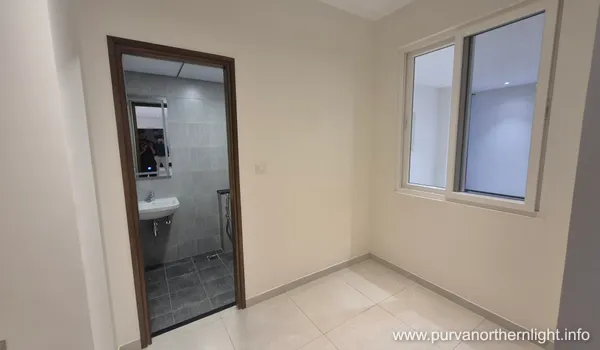 Modern ensuite bathroom at Purva Northern Lights featuring sleek grey tiling and premium sanitary fittings.