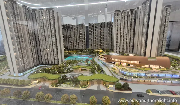 Detail view of the model's ground level, highlighting the Nature-First design with walking trails, reflexology paths, and the Bali-inspired botanical gardens integrated between towers.