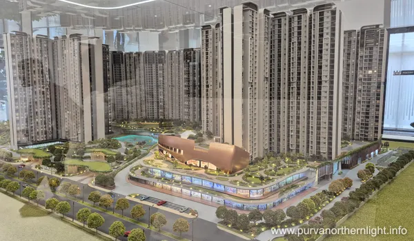 A high-angle view of the architectural scale model of Purva Northern Lights, showing 8 high-rise residential towers surrounded by extensive green landscaping and a central luxury clubhouse.