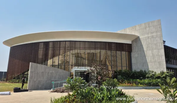 A close-up of the architectural canopy and glass exterior of the Purva Northern Lights project office, reflecting the ongoing site development at KIADB Aerospace Park in March 2026.