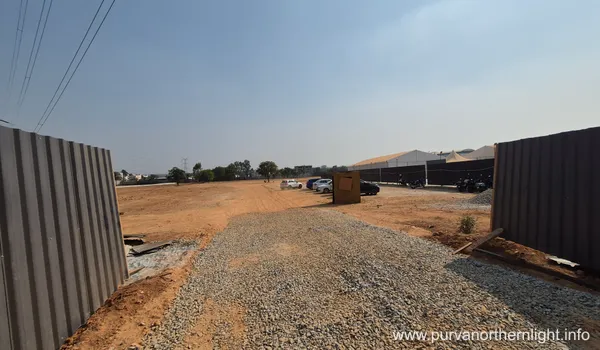 Main entrance and gravel access road at Purva Northern Lights site in March 2026