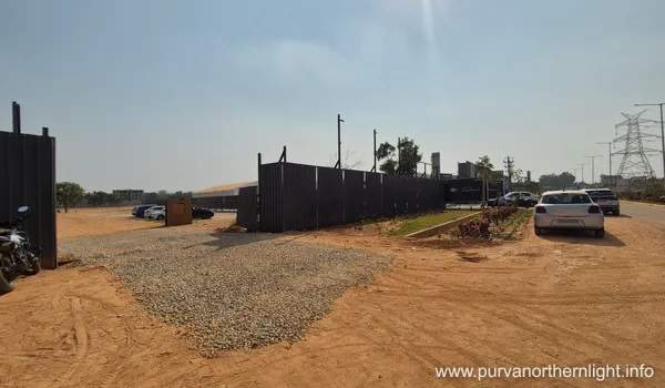 Secured site perimeter with professional fencing and visitor parking area at Purva Northern Lights